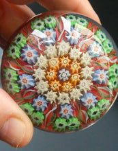 Load image into Gallery viewer,  VASART Scottish Glass Paperweight with 9 Spokes; with rose pink ground, latticino canes &amp; millefiori rosette
