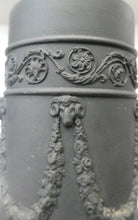 Load image into Gallery viewer, WEDGWOOD Edwardian Black Basalt Spill Vase with Ancanthus Scolls, Garlands, Ram&#39;s Head Mask. Height 8 1/2 inches
