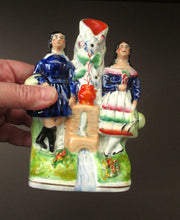 Load image into Gallery viewer, Antique Staffordshire Miniature Spill Vase. A Courting Couple Standing at a Well over a Stream
